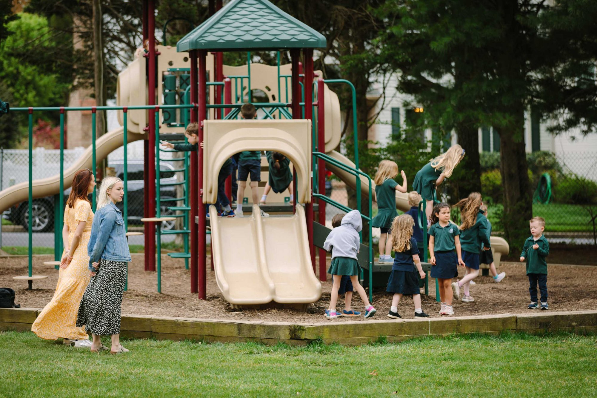pre-k kids on playground on campus