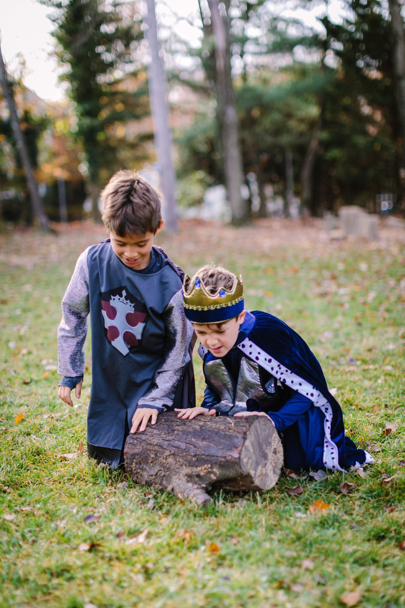 2 boys rolling a log