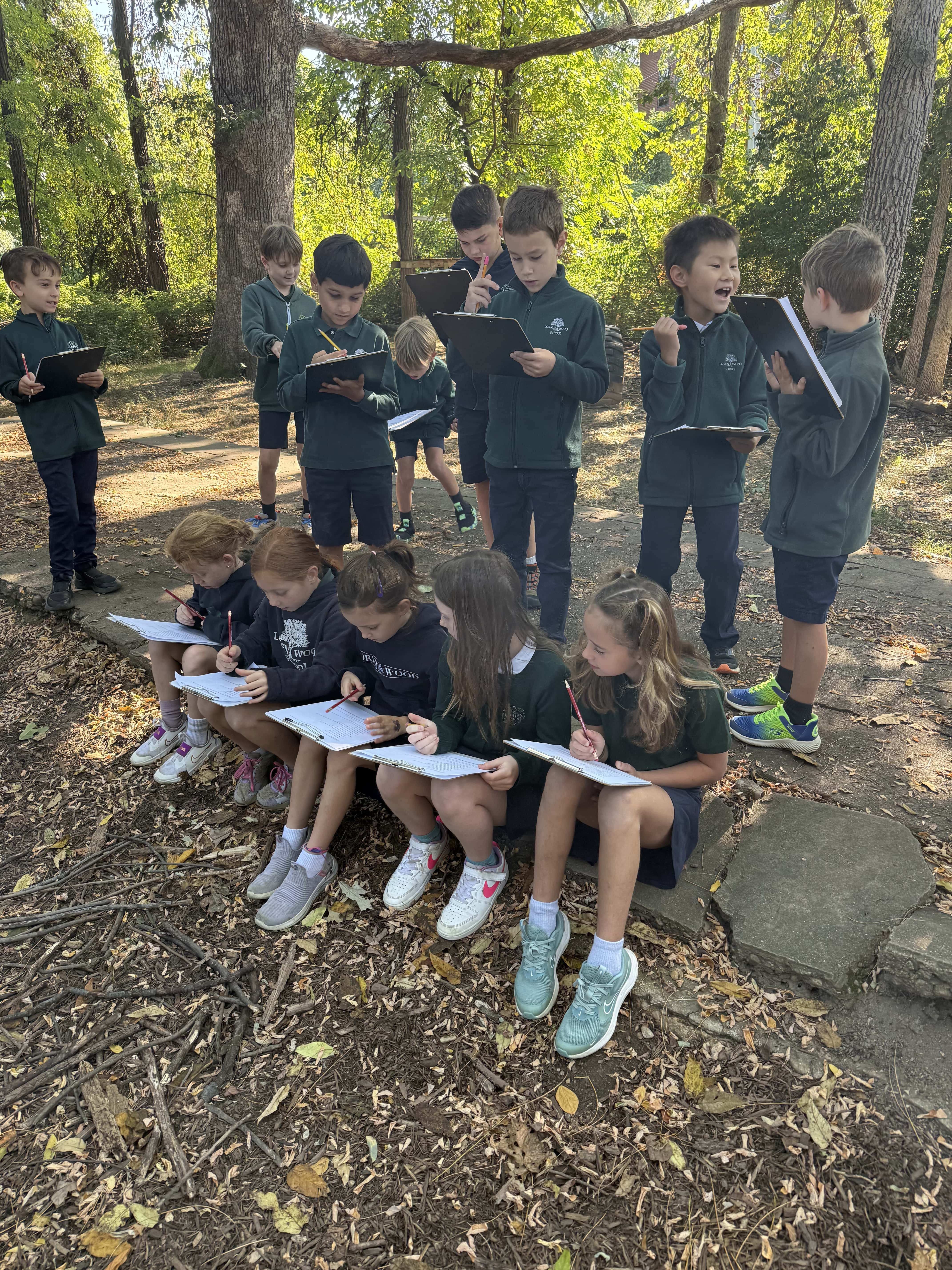 lower school kids outside on notebooks